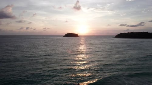A Tropical Island at Sunset in the Middle of Ocean