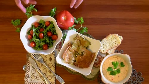 Healthy mediterranean cuisine, three dishes concept for lunch or dinner. Closeup of taking the letuc