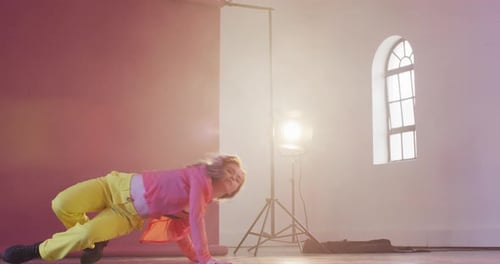 Happy caucasian female dancer dancing alone in dance studio, slow motion