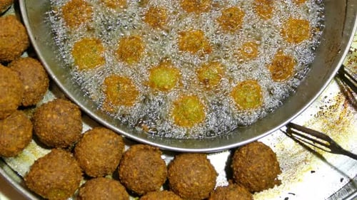 Falafel balls in a deep fryer