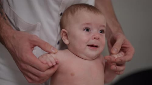 Baby at Doctor's Exam, Crying Then Smiling