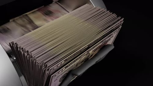 Money Counter Rapidly Counts US Fifty Dollar Bills