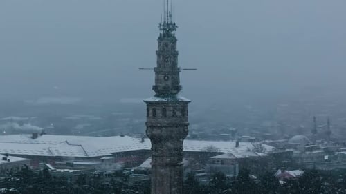 Close Aerial Drone Shot of Historic Tower in Istanbul During Heavy Snowfall