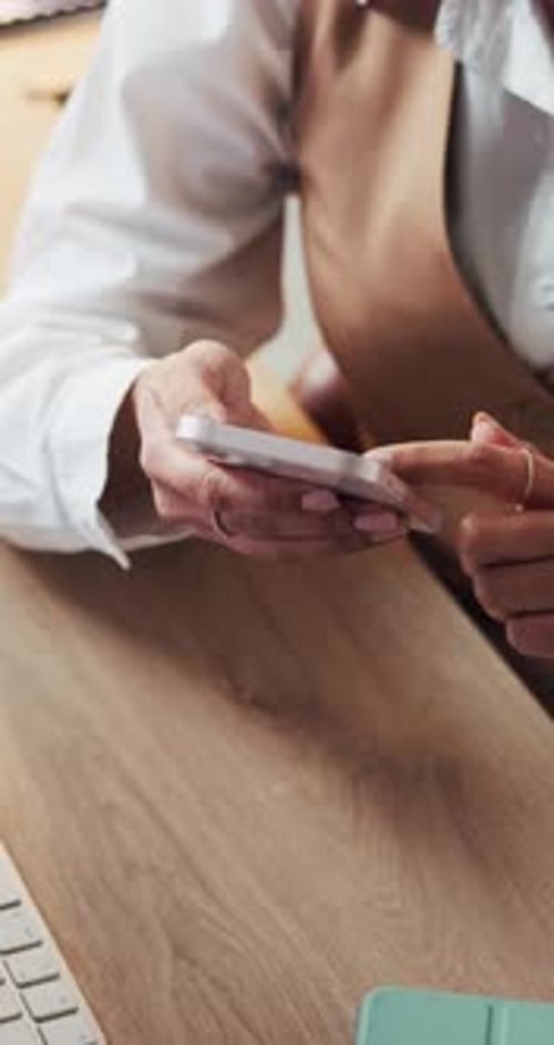 Woman Using a Smartphone at Her Desk