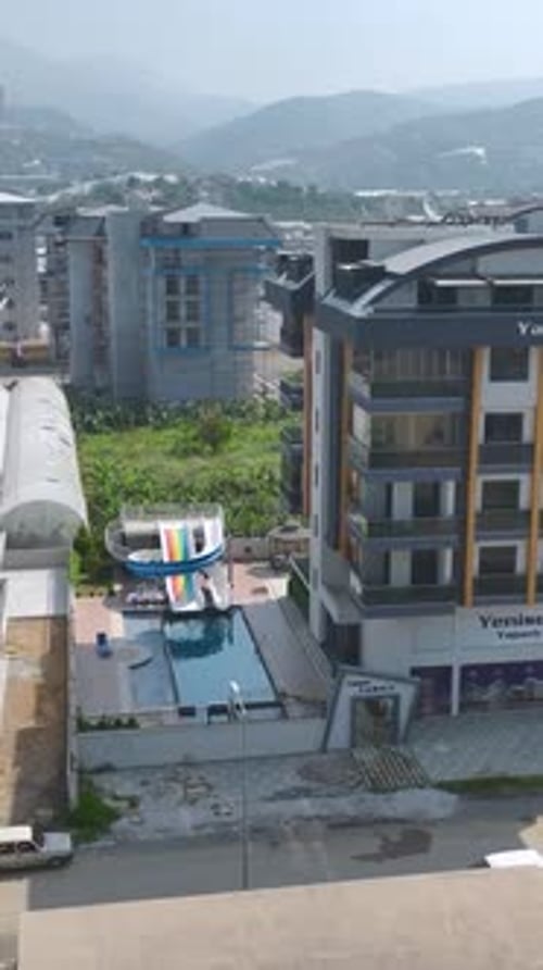 Vertical Video Clear Water Filling a Spacious Pool at a Modern Residential Home