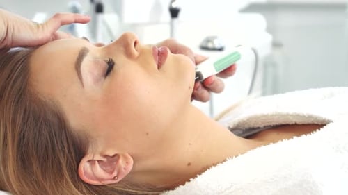 Woman Receives Facial Treatment at Medical Spa