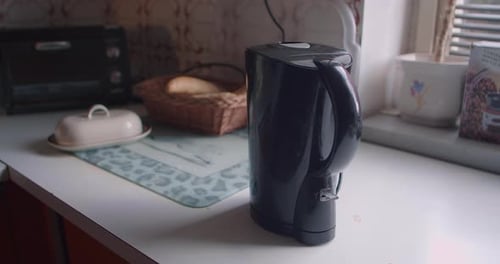 Tea Kettle Being Turned On in Kitchen