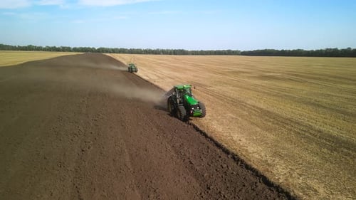 Tractors plowing the field in Ukraine
