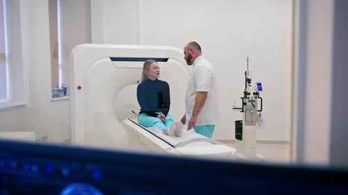 A doctor consults a patient in a medical clinic before an X-ray computed tomography procedure