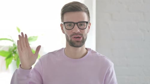 Portrait of Young Man Waving Welcoming