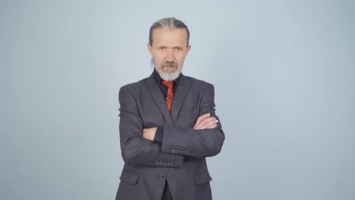 Confident Man in Suit Crossing Arms