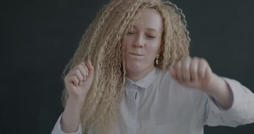 Smiling Woman Dances with Curly Hair