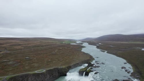 Overcast Aerial View of a Winding River Through Tundra Highlands