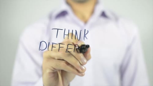 Adult Writes "Think Different" on Clear Surface