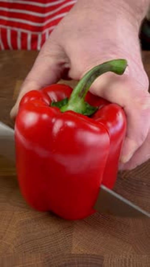 Cutting Red Bell Pepper on Wooden Cutting Board