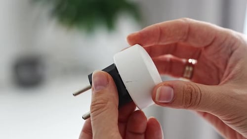 Electrical Plug Adapters with Different Socket Standards in Human Hands International Power