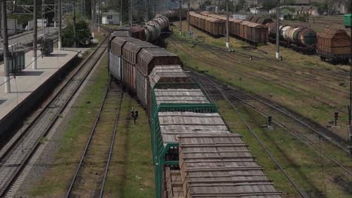 Railway Cargo Trains Moves to Platform Station with oil and wood Wagons
