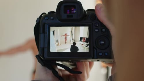 Cameraman Filming Backstage of Bodybuilder Studio Portrait Photoshoot