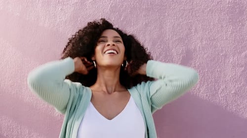 Stylish Woman Posing by a Pink Wall