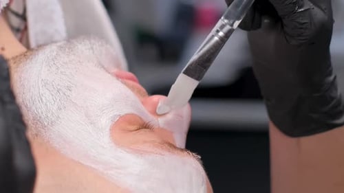 Man Receives Facial Mask with Brush Application