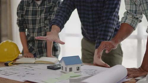 Close up of business's hands selling and buying the house properties.