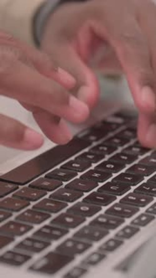 Close Up of Male Hands Typing on Laptop, vertical video