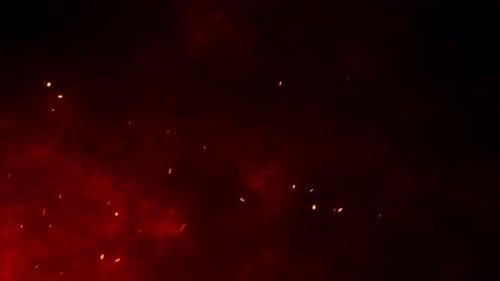 Fire flakes moving towards the maroon sky with the feeling of a huge fire happening.