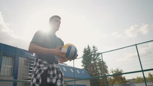 Athlete Bouncing Volleyball During Training in Outdoor Sports Arena