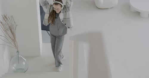 Woman with Braids Dances to Music Indoors