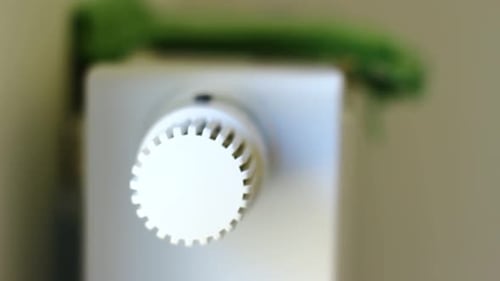 White Thermostat Controlling Home Temperature