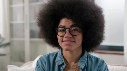 Smiling Young Woman With Afro Hairstyle in Home Setting
