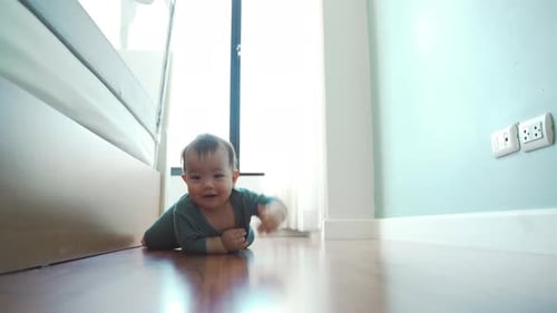 Cute Baby Crawling and Smiling on Wooden Floor