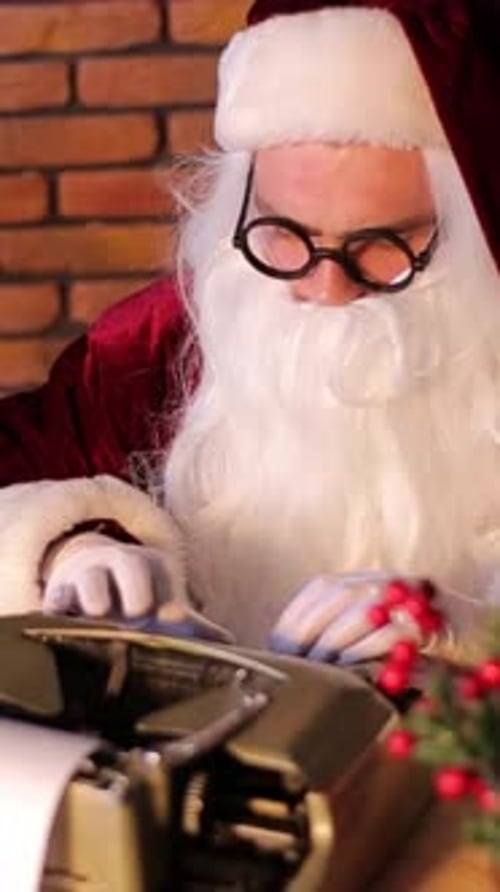 Santa Typing on Typewriter Wearing Round Glasses