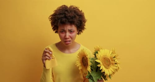 Woman with Sunflowers and Tissue on Yellow Background