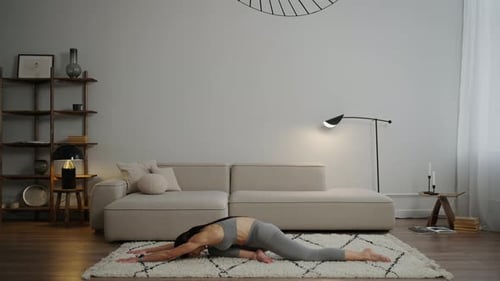 Woman Stretching in Bright Home Living Room