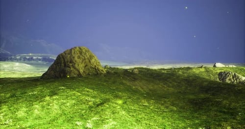Vast Green Landscape with Rocky Formations Under a Deep Blue Sky