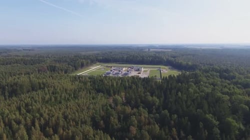 Factory Area In The Middle Of A Coniferous Forest. Aerial Arc Right