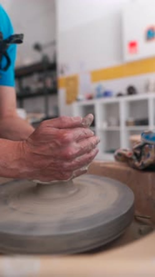 Hands Shaping Clay on a Pottery Wheel