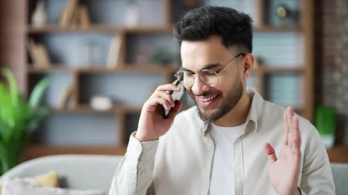 Young Adult Talking on Smartphone Indoors