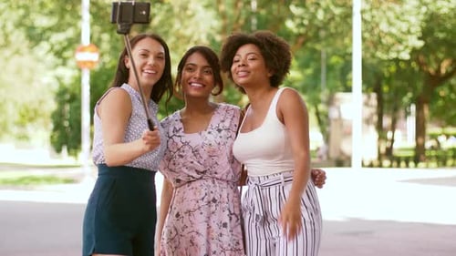 Friendship, Leisure and Technology Concept - Happy Women Taking Picture by Smartphone