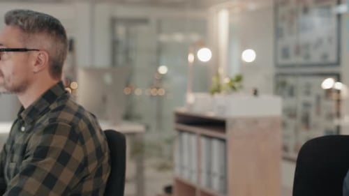 People Working at Computers in an Open Office