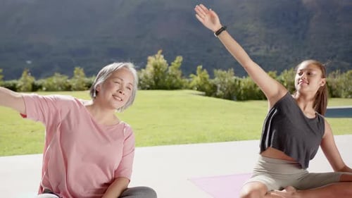 Women Stretching Together During Outdoor Yoga Session