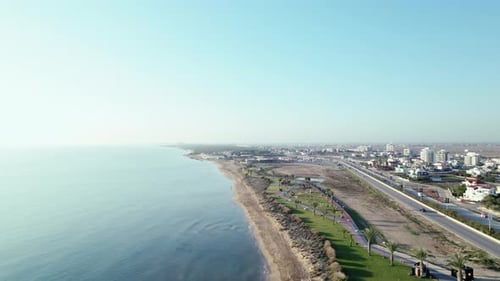 Footage of a Beach Drone Rises Up Above the Sea Surface View of a Small Town Aerial View