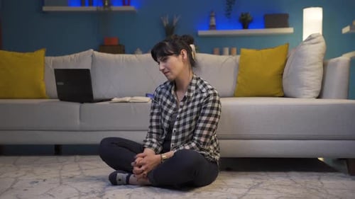 Woman Sitting on Floor Looking Around Calmly
