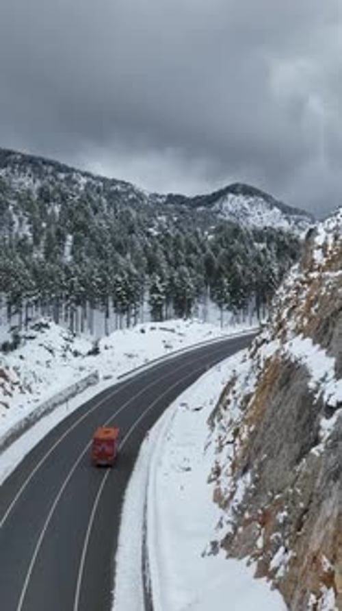 Vertical Video Overhead Capture of SnowCovered Mountain Roads