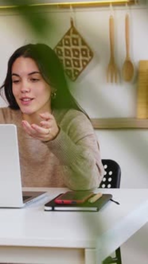 Young Woman Video Calling On Laptop At Home
