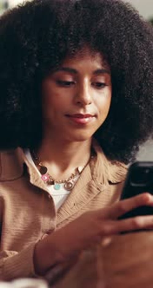 Woman Using Phone and Relaxing Indoors at Home