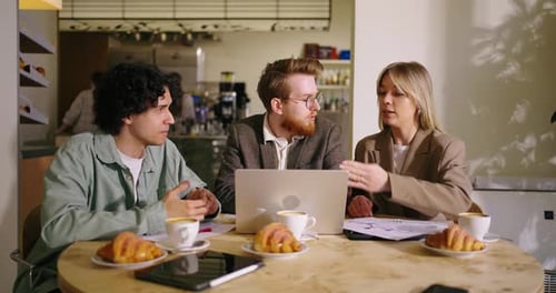 Group Of CoWorkers Meeting In Cafe For Discussing Business Ideas Medium Portrait Businesspeople