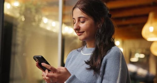 Young Woman Using Phone Indoors