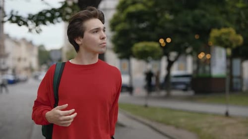 Young Adult Walks on Urban City Street